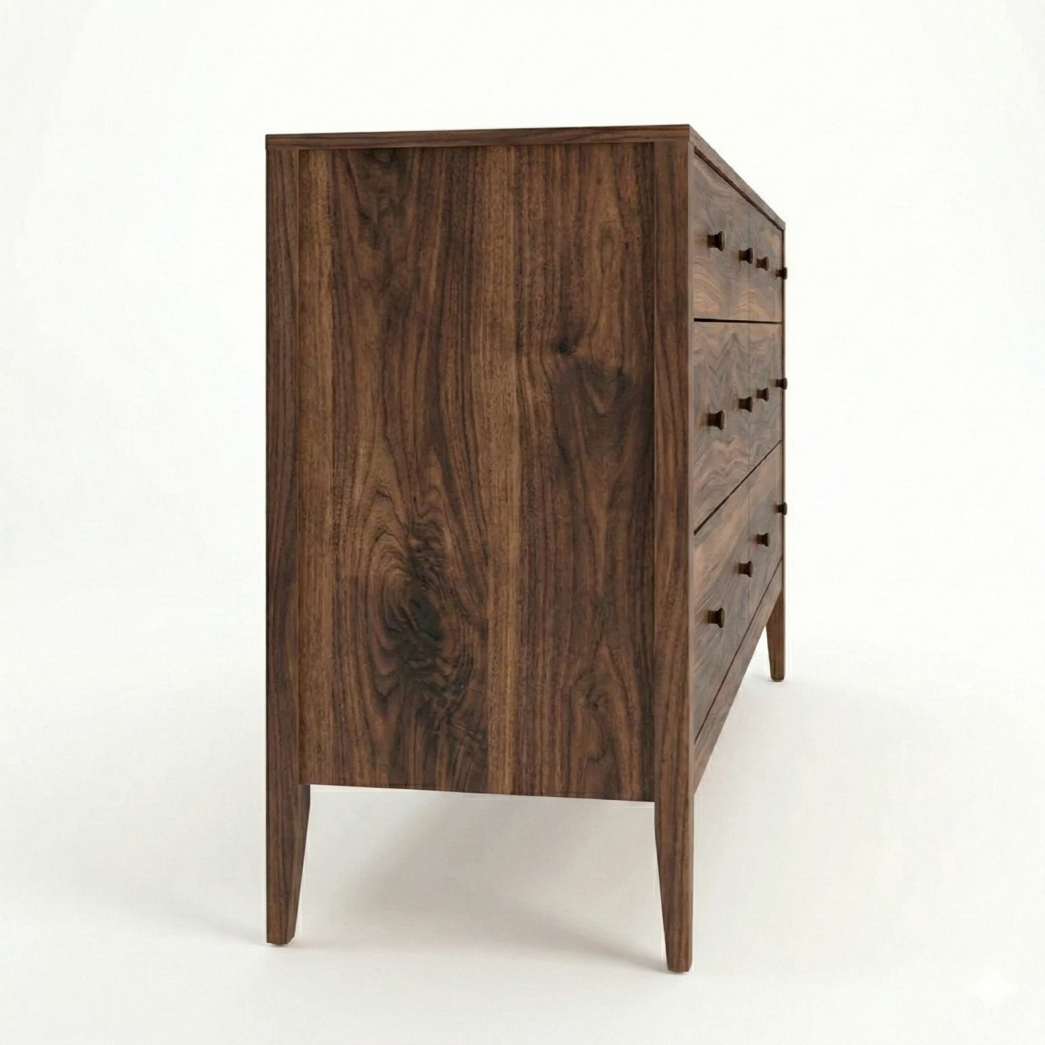 Side view of a solid Walnut natural dresser with black rounded modern knows. Complete with english dovetail joints and clean lines.