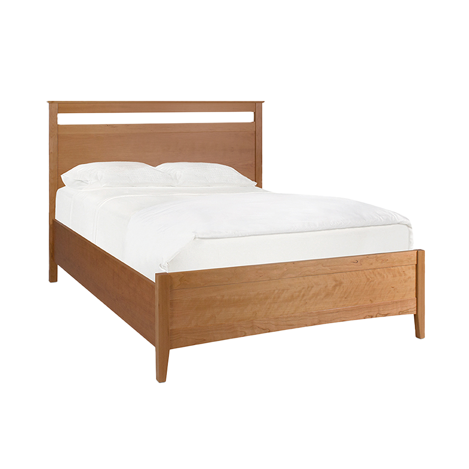 A Solid Cherry panel bed with a low footboard and a white mattress on it