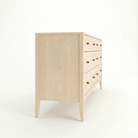 side view of a solid wood hard maple vermont made dresser with black knobs. shown in a vermont woods studio