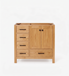 A light oak wood bathroom vanity cabinet with five drawers on the left, two cabinet doors with round black knobs on the right, and a sink cutout on top, shown against a plain white background.